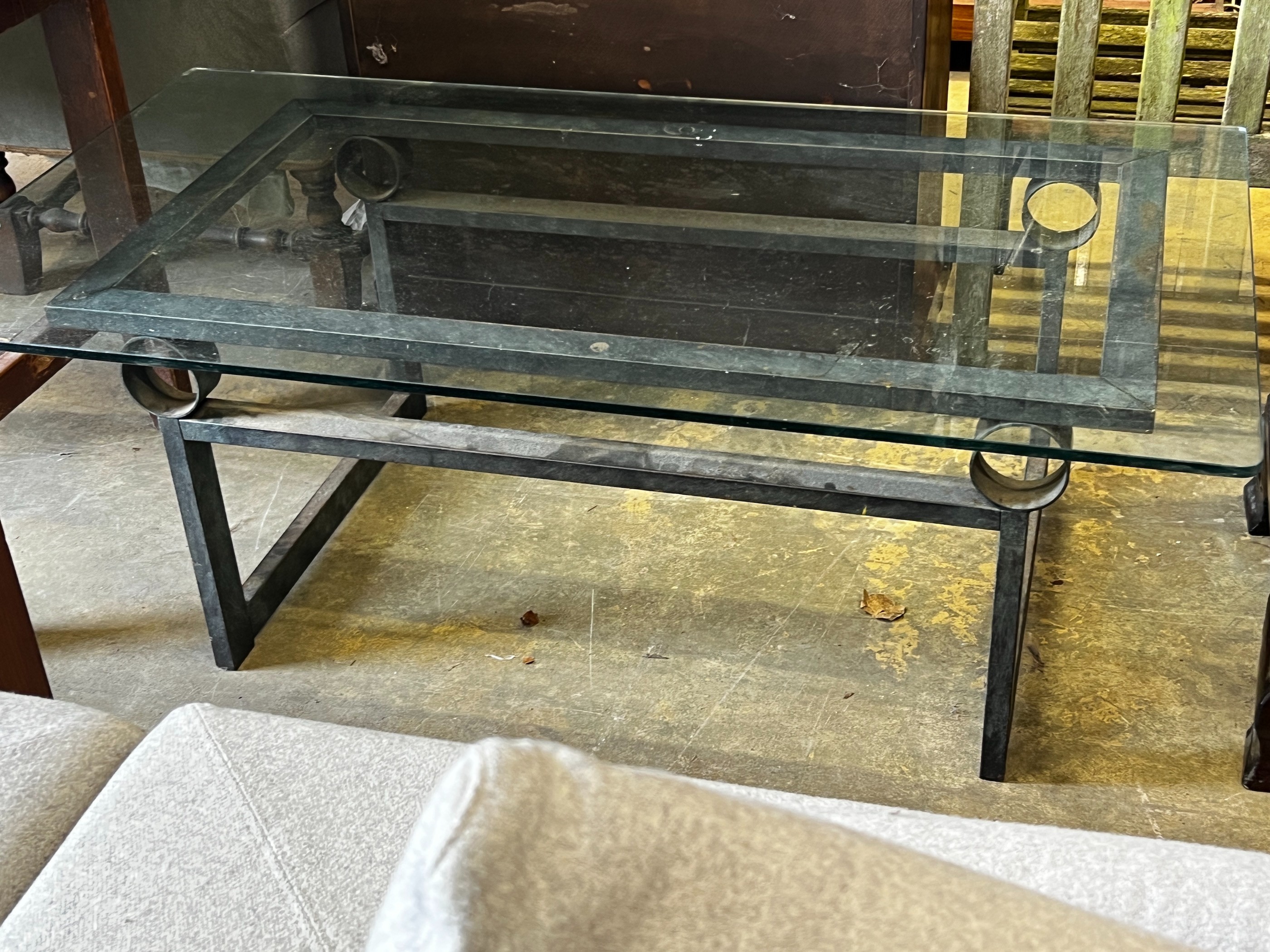 A rectangular glass topped cast metal coffee table, width 137cm, depth 76cm, height 46cm
